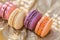 Sweet airy french pastries. Dessert of macarons in the summer evening in the orchard. Shallow depth of field