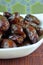 Sweet algerian arabic dates fruits on a white plate