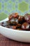 Sweet algerian arabic dates fruits on a white plate