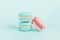 Sweet almond colorful unicorn blue pink macaron or macaroon dessert cake isolated on trendy blue pastel background. French sweet