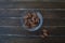 Sweet almonds in a transparent bowl on wood from above