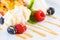 Sweet appetizing dessert with ice-cream, apricot, berries and mi