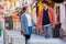 Sweet Asian couple holding hands and staring into eyes each other on Happiness Street.