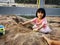 Sweet Asian Little girl playing sand outdoor at home