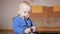 Sweet baby with stethoscope at home. Toddler chews medical device teeth