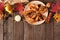 Sweet baked autumn pears, above view, top border on a rustic wood background