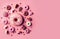 Sweet baked donuts with decoration on a pink background. Generative AI, generative artificial intelligence