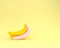 Sweet banana pink polka dots on yellow pastel background. minima