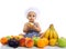 Sweet beautiful baby cook eating healthy fruits