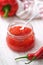 Sweet bell pepper and chili pepper sauce, confiture, jam in a glass jar.