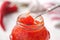 Sweet bell pepper and chili pepper sauce, confiture, jam in a glass jar.