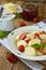 Sweet berry breakfast. Sweet lazy pierogi, dumplings with sour cream, butter and strawberry on wooden background. Italian gnocchi.