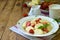 Sweet berry breakfast. Sweet lazy pierogi, dumplings with sour cream, butter and strawberry on wooden background. Italian gnocchi.