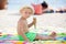 Sweet blonde toddler boy, eaiting ice cream on the beach