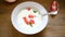 Sweet boiled semolina porridge in a plate with slices of red grapefruit