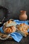 Sweet braided buns with sesame seeds on a blue kitchen towel.