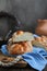 Sweet braided buns with sesame seeds on a blue kitchen towel.