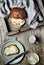 Sweet bread, a cup of cocoa milk and butter on vintage wooden background