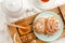 Sweet buns with walnuts, grated coconut and honey on a wooden tray. Breakfast concept. Top view