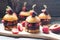 Sweet burgers with brioche bun, chocolate brownie layer, fresh strawberries and chocolate sauce