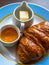 Sweet buttery croissants, fruity jam, butter curl