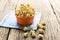 Sweet caramel popcorn in a bowl on blue cotton napkin against wooden background