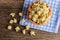 Sweet caramel popcorn in a bowl on blue cotton napkin against wooden background