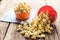 Sweet caramel popcorn in a bowl on blue cotton napkin against wooden background