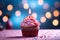 Sweet celebration Cupcake with pink cream and burning candle