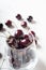 Sweet cherries in cherry glass bowl around white. close up