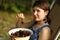 Sweet cherry merry in human hand with teenager girl on background