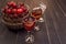 Sweet cherry,plum,quince liquein ice glass on black table and sweet cherries in golden vase