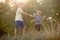 Sweet children, boys, playing in the park on sunset, autumn