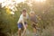 Sweet children, boys, playing in the park on sunset, autumn