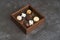 Sweet chocolate candies in wooden box, close-up. A set of assorted chocolates