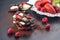 Sweet chocolate slices with fruits with cocoa powder and fruit on metal white plate. sweet dessert on black backgroud