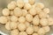 Sweet coconut laddoo or coconut balls in a bowl