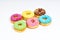 Sweet colorful glazed doughnuts on white background. Junk food top view, sugar treat