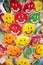 Sweet colorful laughing lollipops on street market as a background