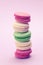 Sweet and colourful french macaroons or macaron on light purple