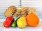 Sweet cookies are in a cage locked with padlock. Vegetables and fruits are in the foreground. Healthy eating and ban on junk food