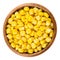 Sweet corn kernels in wooden bowl over white