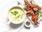 Sweet corn mashed soup with bacon tomato parmesan whole grain bread toast on light background, top view