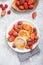 Sweet Cottage cheese pancakes on plate served strawberries. Russian syrniki, ricotta fritters or curd fritters