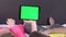 Sweet couple on bed watching something on white tablet gadget, green screen