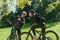 A sweet couple, equipped with bicycles and engrossed in coordinating their journey, checks their GPS mobile and watches