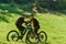 A sweet couple, equipped with bicycles and engrossed in coordinating their journey, checks their GPS mobile and watches