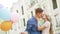 Sweet couple kissing in street, romantic date with colorful balloons, happiness