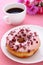 Sweet cranberry donut with a cup of coffee