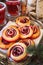 Sweet cranberry roll buns with chocolate drops and cranberry fruit drink